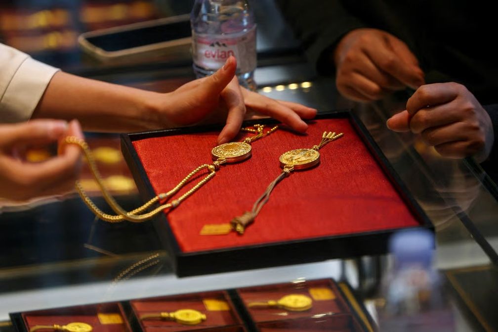 Сотрудник обслуживает покупателя в магазине Laopu Gold в Пекине. Фото: Reuters