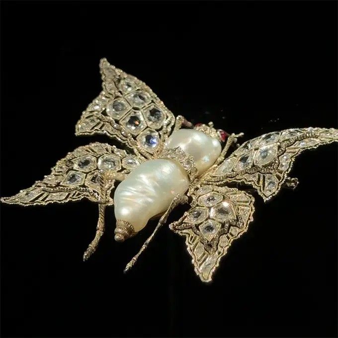 Брошь в виде бабочки 1950-х годов работы Марио Буччеллати из белого золота с барочным жемчугом, рубинами и бриллиантами Брошь в виде бабочки 1950-х годов работы Марио Буччеллати из белого золота с барочным жемчугом, рубинами и бриллиантами